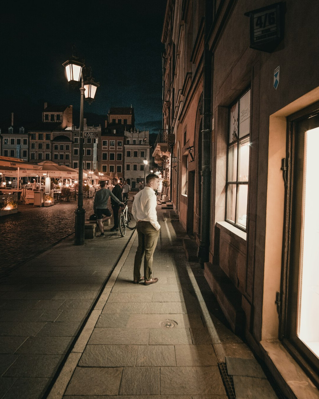Documentary photographer holding a camera on a city street in Poland