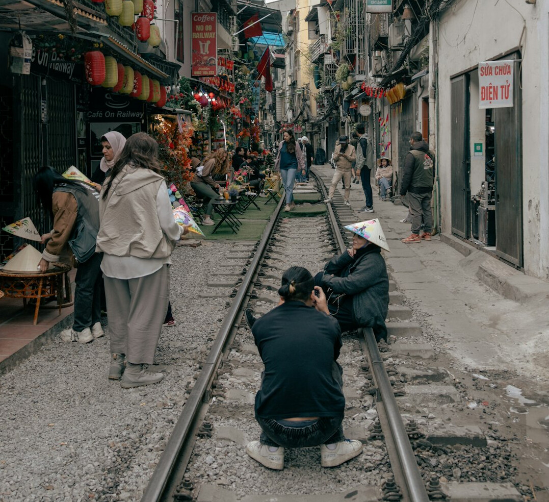Photojournalist crouching to photograph a street scene