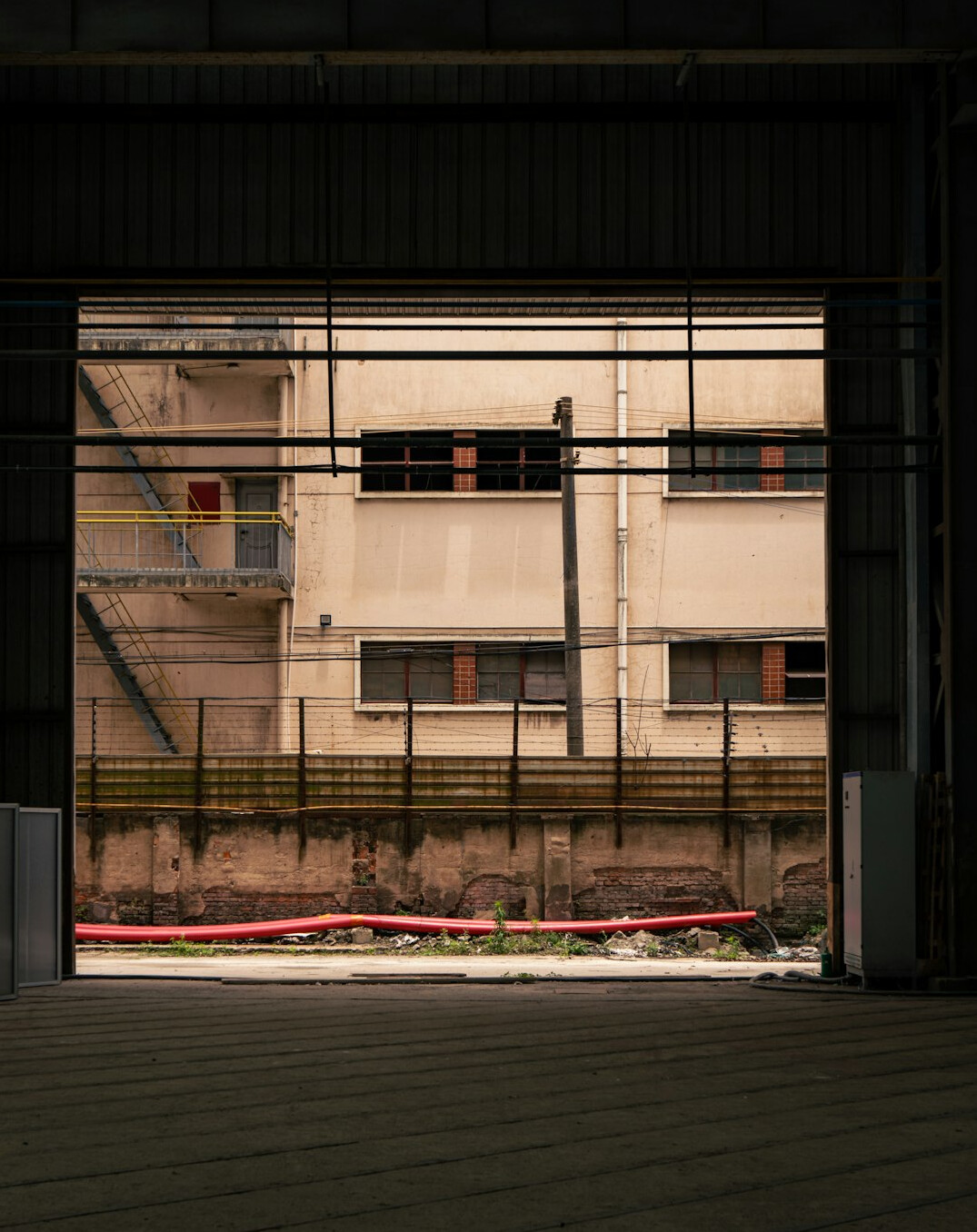 elderly man walking factory fence